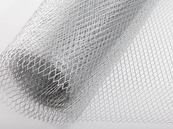 A roll of light type expanded metal on the grey background