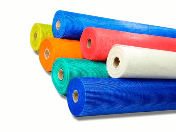 Seven rolls of fiberglass cloth in white, yellow, blue, green, red, and orange color.