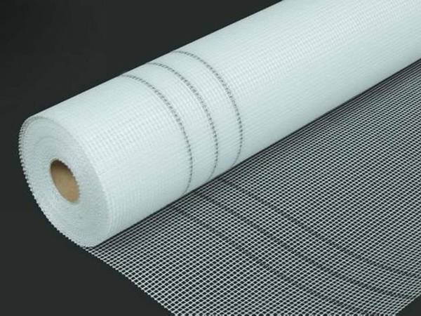 A roll of white fiberglass mesh in black background with 2×2mm mesh size