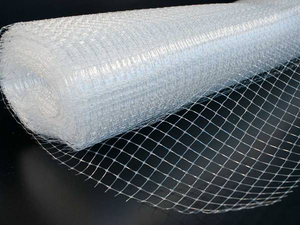 A roll of plastic plaster mesh on the black background