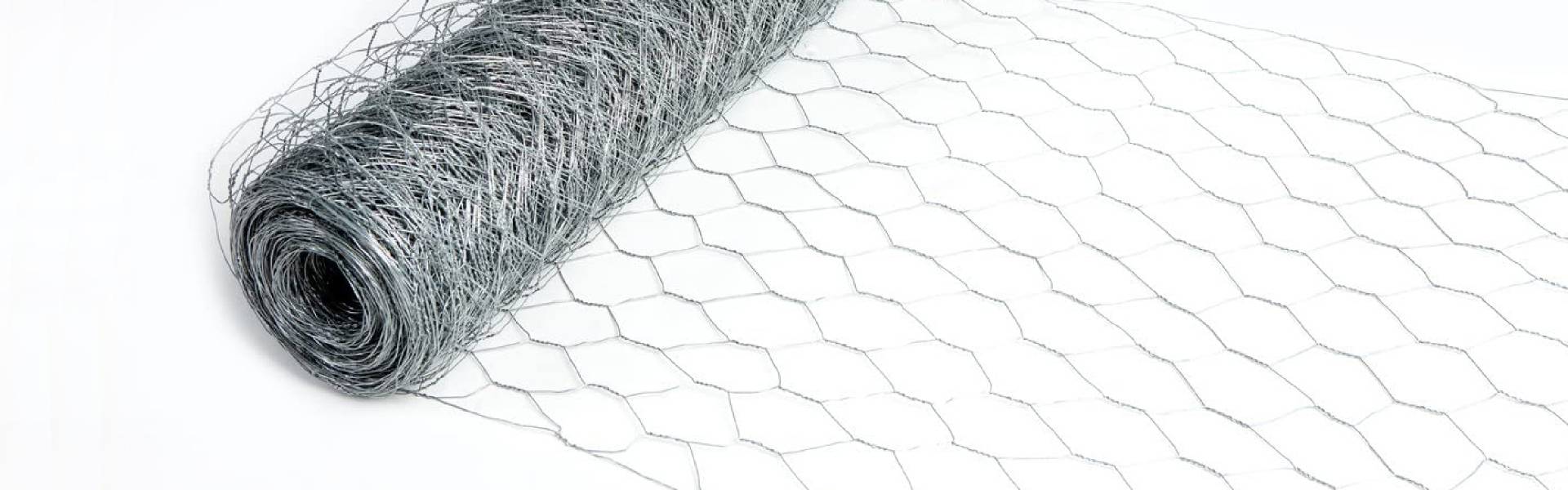 Plaster chicken wire fabric unrolls and shows the details of its mesh opening.