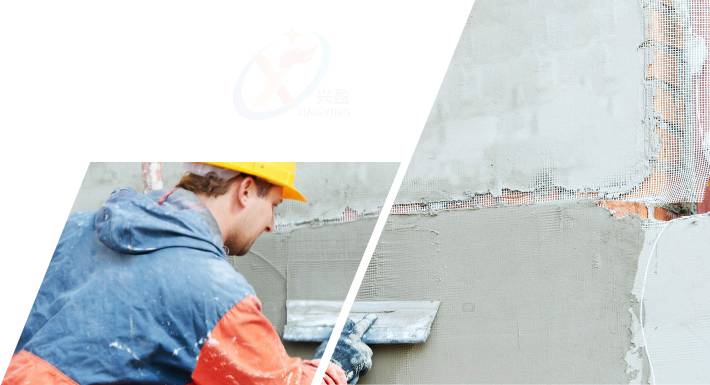 A construction worker is plastering concrete evenly on the wall.